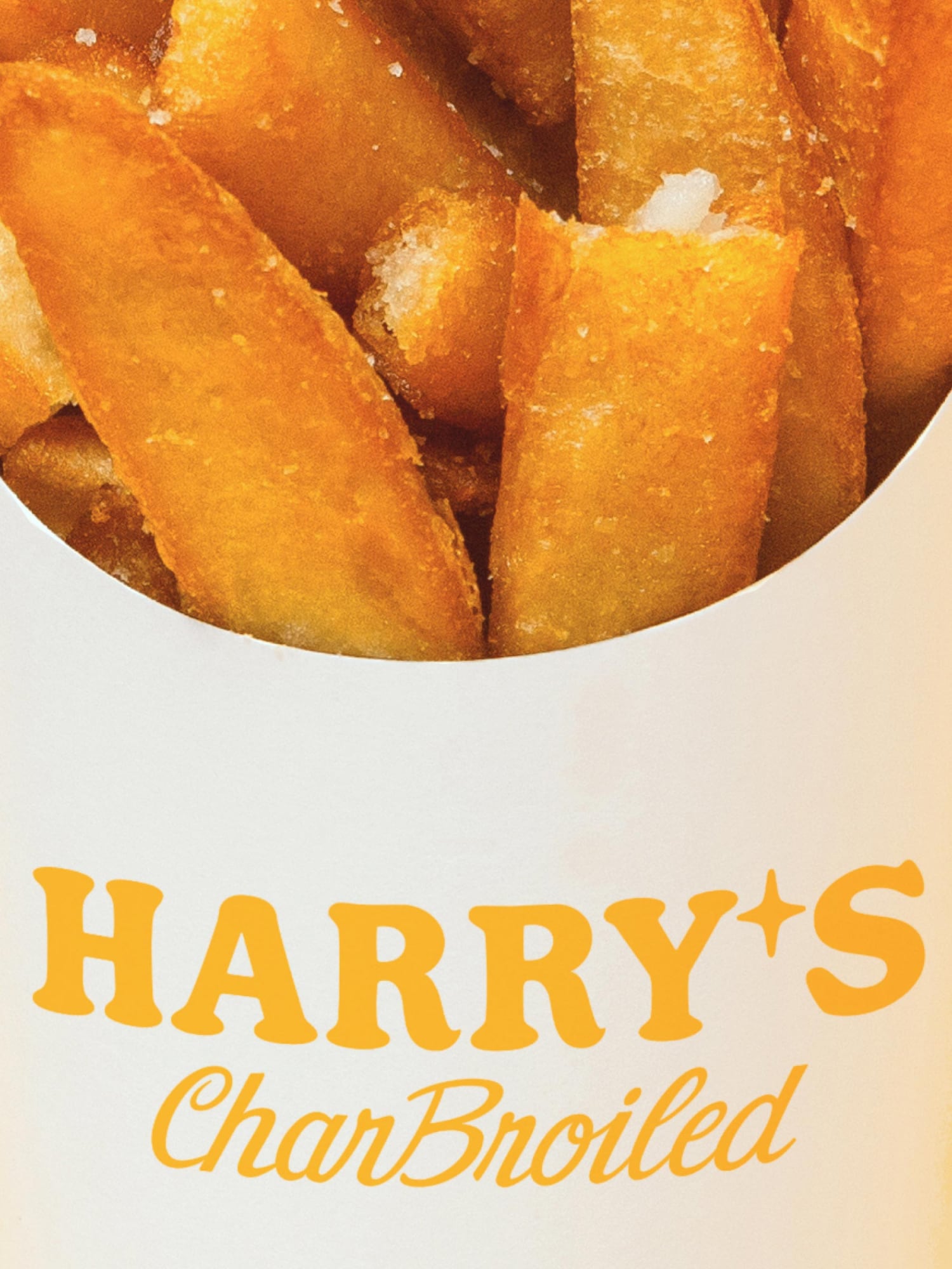Detail of fries packaging with the Harry’s Charbroiled wordmark